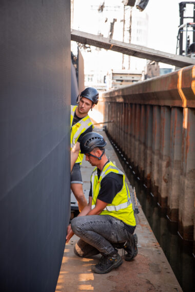 AV technicians installing LED screens next to the stage.